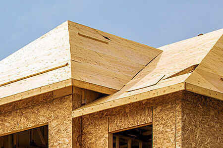 Home under construction with sheathing on the roof and walls in Melbourne, Florida.